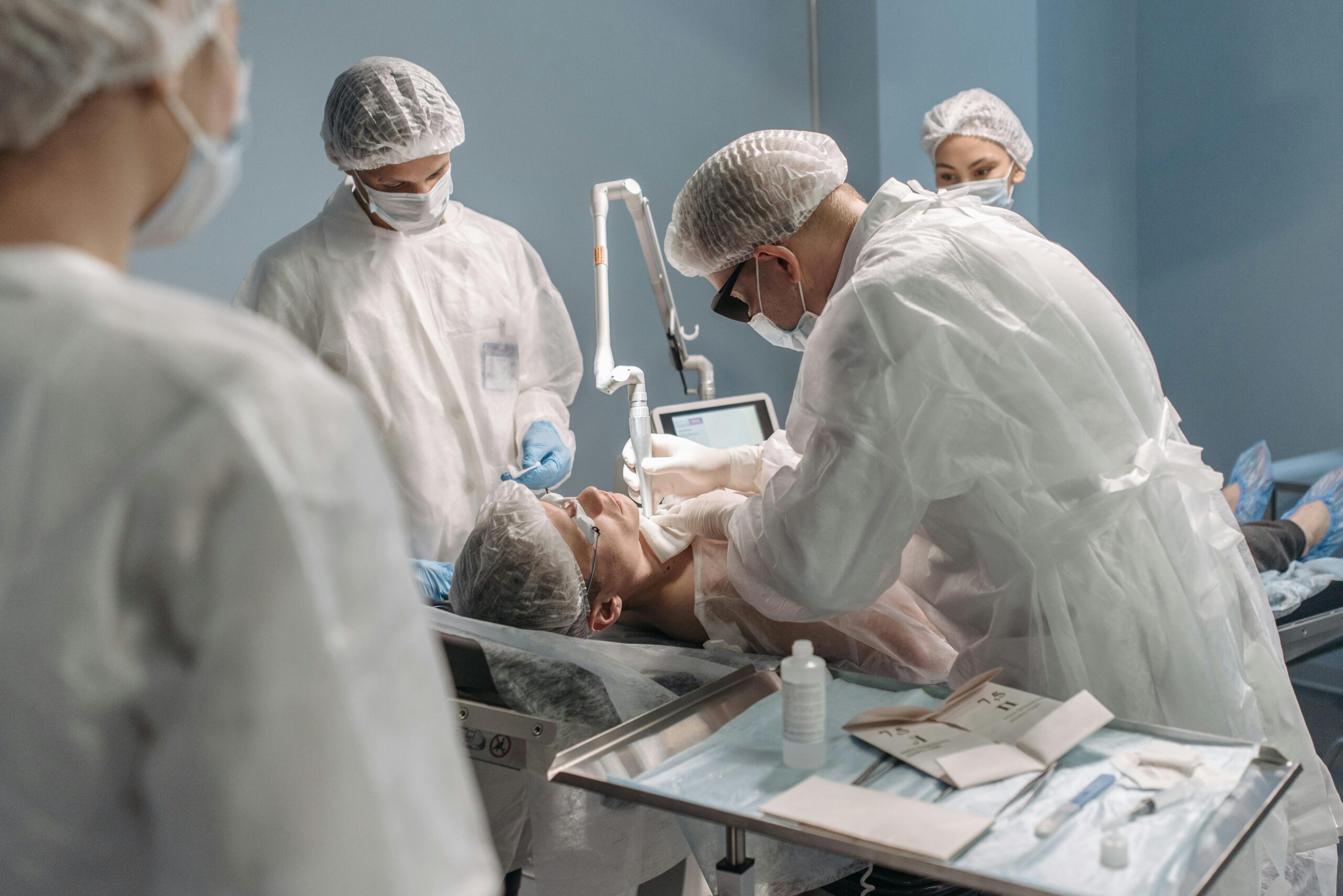 Team of surgeons conducting surgery with precision in a modern operating room setting.